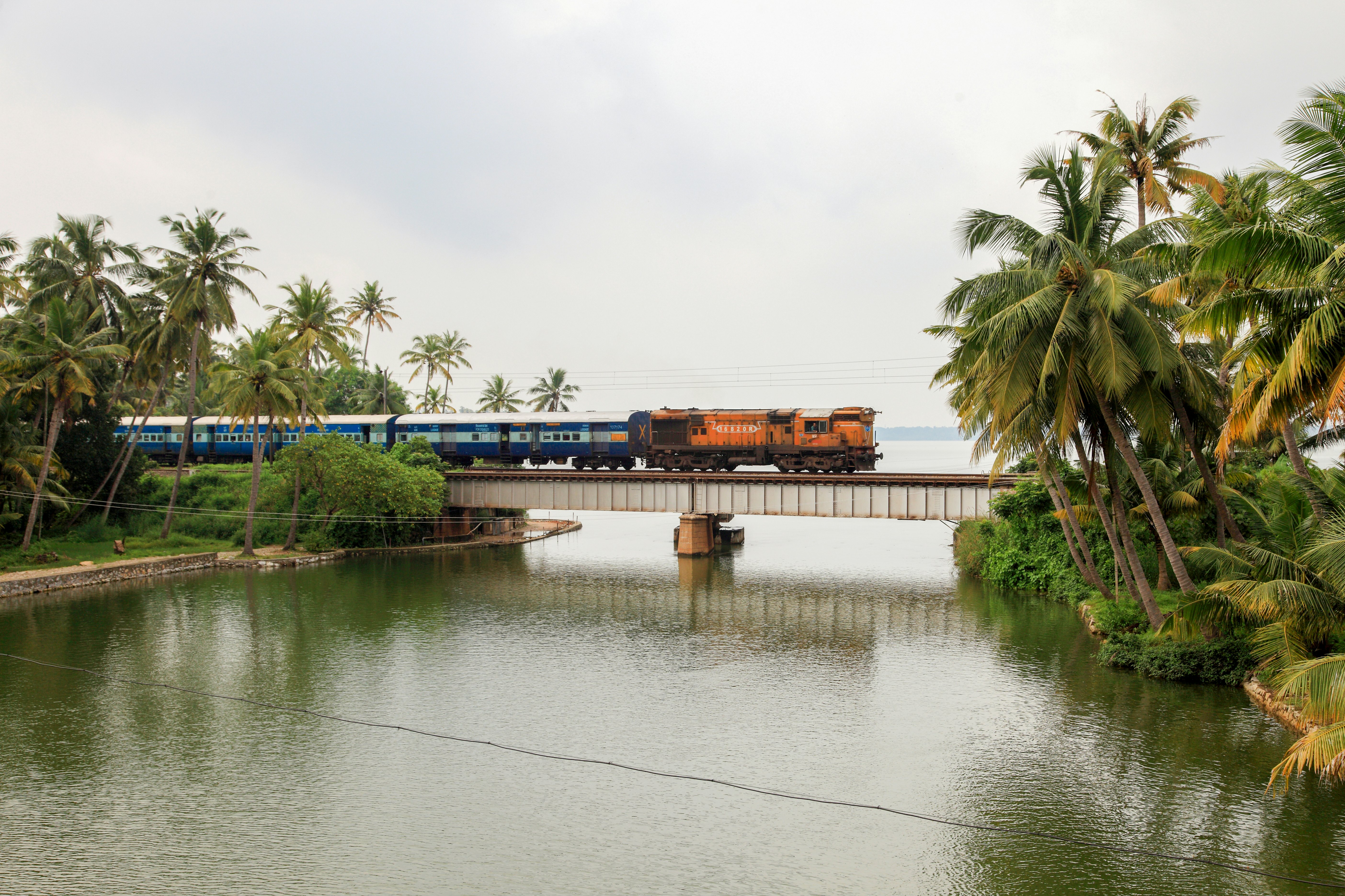 A train passes through a railway bridge in Manroe Island on in Kollam, Kerala, India