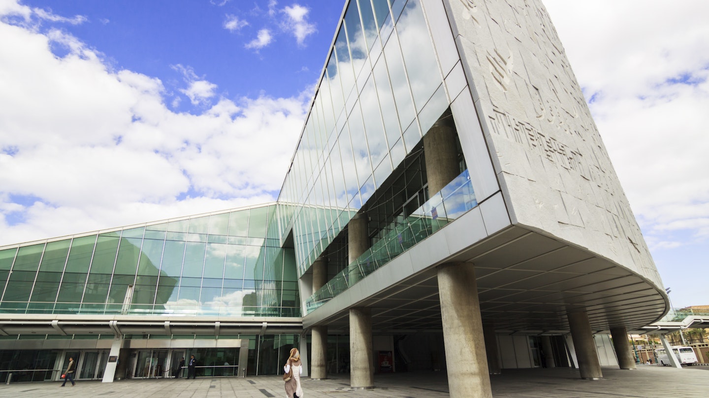 Alexandria, Egypt - October 21, 2011 : A young student stands by the glass facade of the New Library of Alexandria or Bibliotheca Alexandrina inaugurated on 16 October 2002.
911030956
building, cultural center, curving wall, glass, glass architecture, glass building, glass gallery, modern architecture, new library, street scene, wall