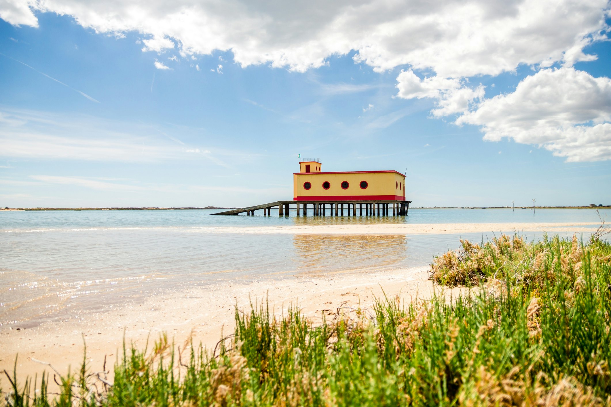 A sunny beach view of the historical lifeguard building in Fuseta.