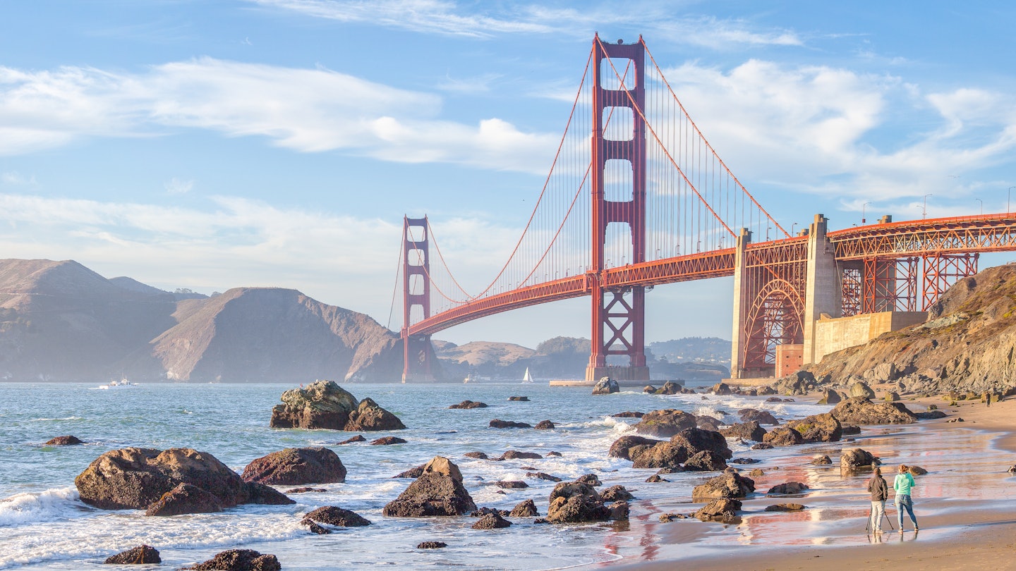 Classic panoramic view of famous Golden Gate Bridge seen from scenic Baker Beach in beautiful golden evening light on a sunny day with blue sky and clouds in summer, San Francisco, California, USA License Type: media Download Time: 2021-08-23T02:27:27.000Z User: mvm_lonelyplanet Is Editorial: No purchase_order: